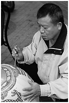 Man painting paper lantern. Lukang, Taiwan (black and white)