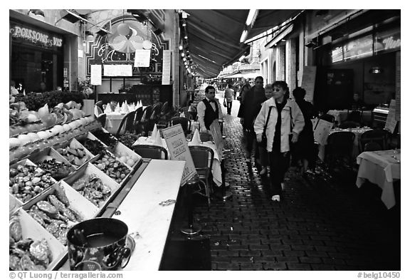 Rue des Bouchers, a narrow cobbled street lined with restaurants. Brussels, Belgium (black and white)