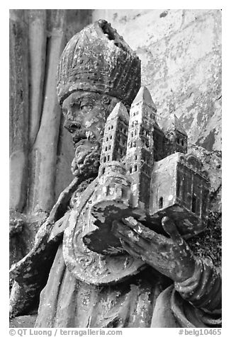 Statue outside of Notre Dame Cathedral showing a model of the cathedral being held. Tournai, Belgium (black and white)
