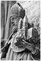 Statue outside of Notre Dame Cathedral showing a model of the cathedral being held. Tournai, Belgium (black and white)