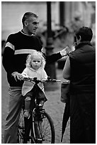 Blond little girl sitting on bicycle. Bruges, Belgium (black and white)