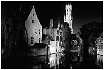 Old houses and beffroi reflected in canal at night. Bruges, Belgium ( black and white)