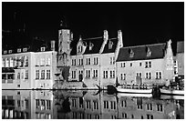 Houses reflected in canal, Rozenhoedkaai, night. Bruges, Belgium (black and white)