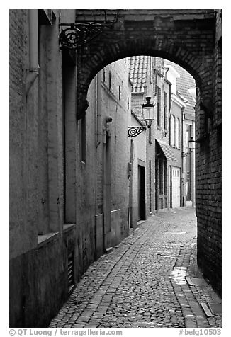 Narrow cobled street and archway. Bruges, Belgium