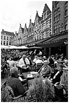 People in restaurants on the Markt. Bruges, Belgium (black and white)