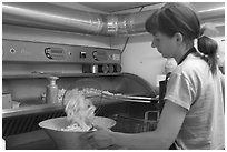 Woman cooking fries in a booth. Bruges, Belgium (black and white)