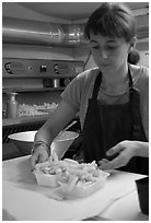 Woman serving fries in a booth. Bruges, Belgium (black and white)