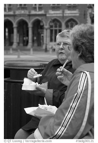 Elderly women eating fries. Bruges, Belgium (black and white)