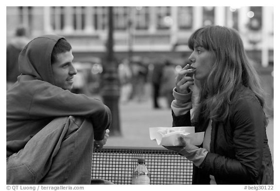 Young woman eating fries, Markt. Bruges, Belgium (black and white)