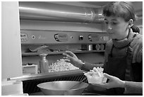 Woman preparing fries in a booth. Bruges, Belgium (black and white)