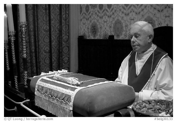 Priest and relic of Christ's blood. Bruges, Belgium (black and white)