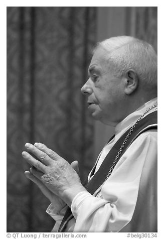 Priest in the Heilig-Bloedbasiliek. Bruges, Belgium (black and white)