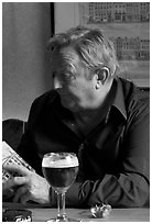 Man with book and beer. Brussels, Belgium (black and white)