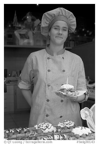 Vendor holding a Belgian waffle. Brussels, Belgium (black and white)