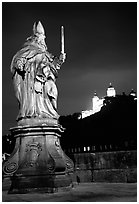 Saint Killian statue on  Alte Mainbrucke (bridge) and Festung Marienberg (citadel) at night. Wurzburg, Bavaria, Germany (black and white)