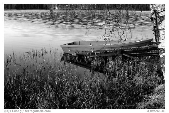 Red boat on a lakeshore. Central Sweden (black and white)