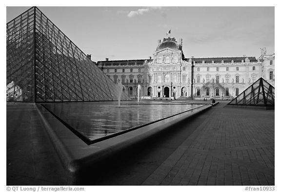 Pyramid and basins, and Sully Wing  in the Louvre, sunset. Paris, France (black and white)