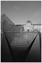 Pyramid and triangular basin in the Louvre, sunset. Paris, France (black and white)