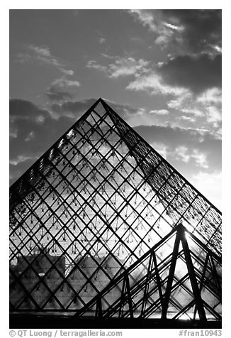 Louvre pyramid transparent at sunset. Paris, France