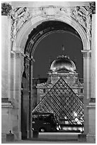 Louvre, pyramid, and bus seen through the Carousel Arch at night. Paris, France ( black and white)