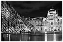 Pyramid, basin, and Louvre at night. Paris, France (black and white)