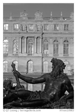 Statue, basin, and Versailles palace facade, late afternoon. France (black and white)