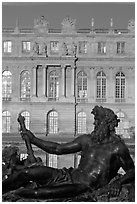 Statue, basin, and Versailles palace facade, late afternoon. France (black and white)