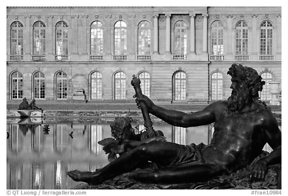 Statue, basin, and facade, late afternoon, Versailles Palace. France