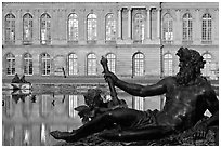 Statue, basin, and facade, late afternoon, Versailles Palace. France (black and white)