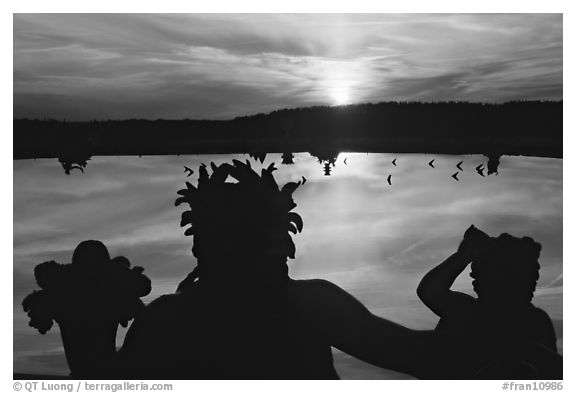 Sunset over a basin in the Versailles palace gardens. France (black and white)