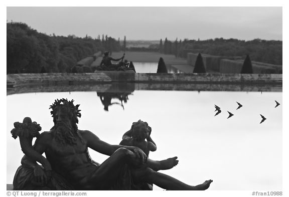 Sculptures, basin, and gardens at dusk, Palais de Versailles. France (black and white)