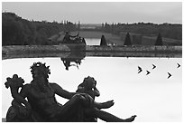 Sculptures, basin, and gardens at dusk, Palais de Versailles. France (black and white)