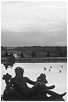 Sculptures, basin, and gardens at dusk, Versailles Palace. France (black and white)