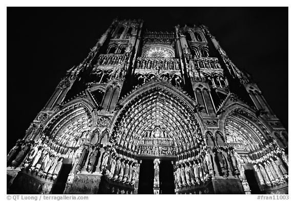 Looking up Notre Dame Cathedral laser-illuminated to recreate original colors, Amiens. France