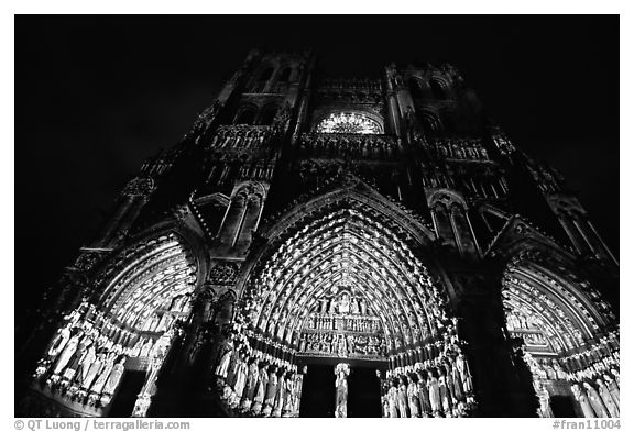 Looking up cathedral with doors laser-illuminated to recreate original colors, Amiens. France