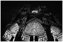 Looking up cathedral with doors laser-illuminated to recreate original colors, Amiens. France (black and white)