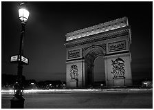 Street lamp and Etoile triumphal arch at night. France ( black and white)