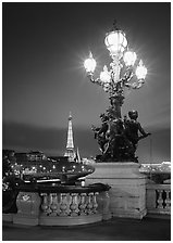 Lamps on Pont Alexandre III and Eiffel Tower at night. Paris, France ( black and white)