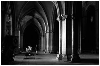 Worshiper inside the Saint-Etienne Cathedral. Bourges, Berry, France (black and white)