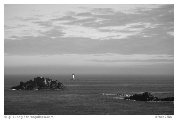 Islets and lighthouse on the coast. Brittany, France