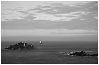 Islets and lighthouse on the coast. Brittany, France (black and white)