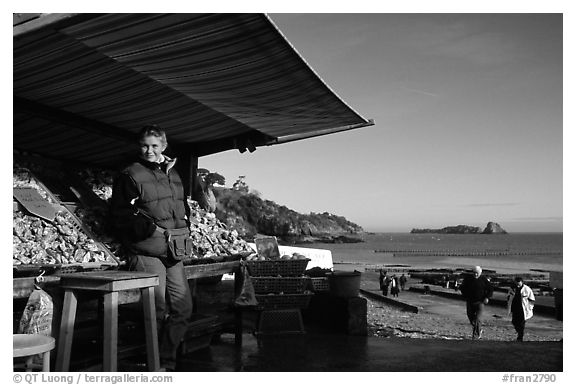 Oyster stand and vendor in Cancale. Cancale oysters are reknown in France. Brittany, France (black and white)