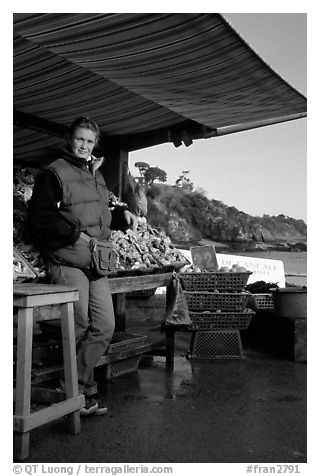 Oyster stand and vendor in Cancale. Brittany, France