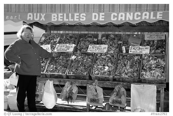 Oyster stand and vendor in Cancale. Brittany, France