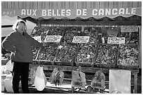 Oyster stand and vendor in Cancale. Brittany, France ( black and white)