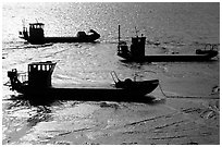 Flat-bottom fishing boats at low tide, Cancale. Brittany, France ( black and white)