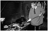 Baking the famous Omelette de la mere Poularde at the eponymous restaurant. Mont Saint-Michel, Brittany, France (black and white)