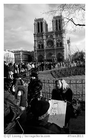 Sketch drawers in front of Notre Dame Cathedral. Paris, France (black and white)