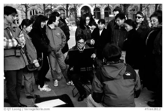 Sketch drawer surrounded by onlookers. Paris, France