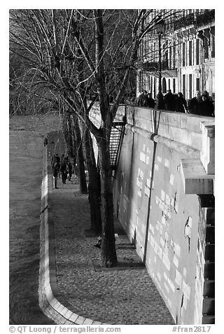 Walking on the banks of the Seine on the Saint-Louis island. Paris, France (black and white)